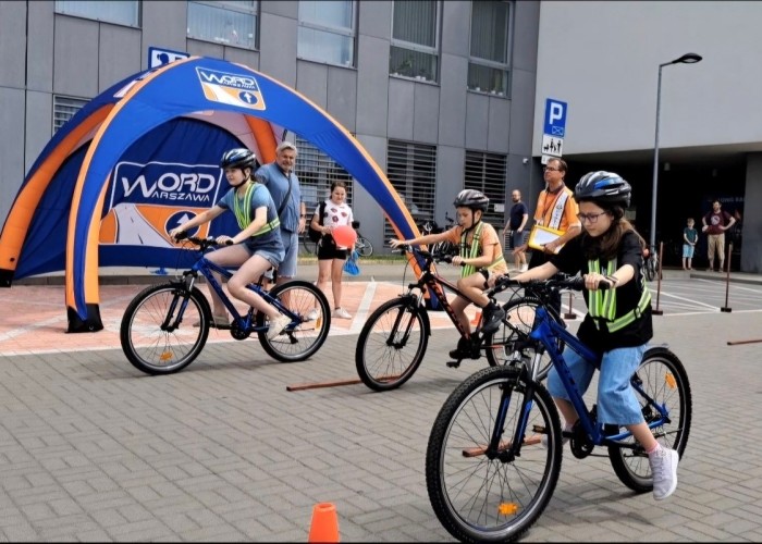 Zdjęcie 3. Uczestnicy eliminacji w konkursie z jazdy po torze rowerowym oraz Egzaminator z WORD w Warszawie Sławomir Bakalarski. (Zdjęcia źródło: WORD w Warszawie)